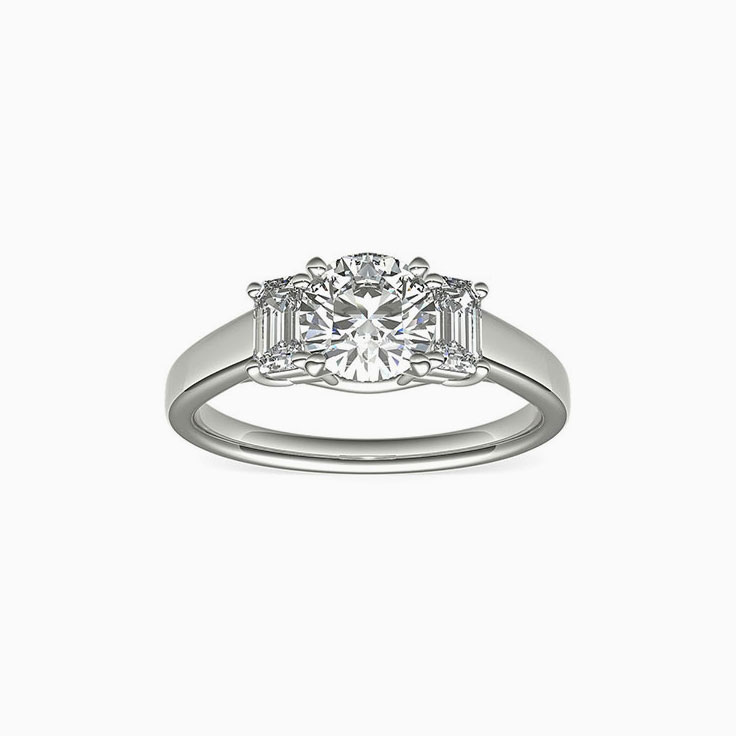 Classic Round Diamond And Emerald Cut Side Stone Engagement Ring