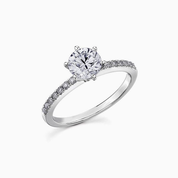 Round brilliant cut diamond in a six claw setting an diamond band