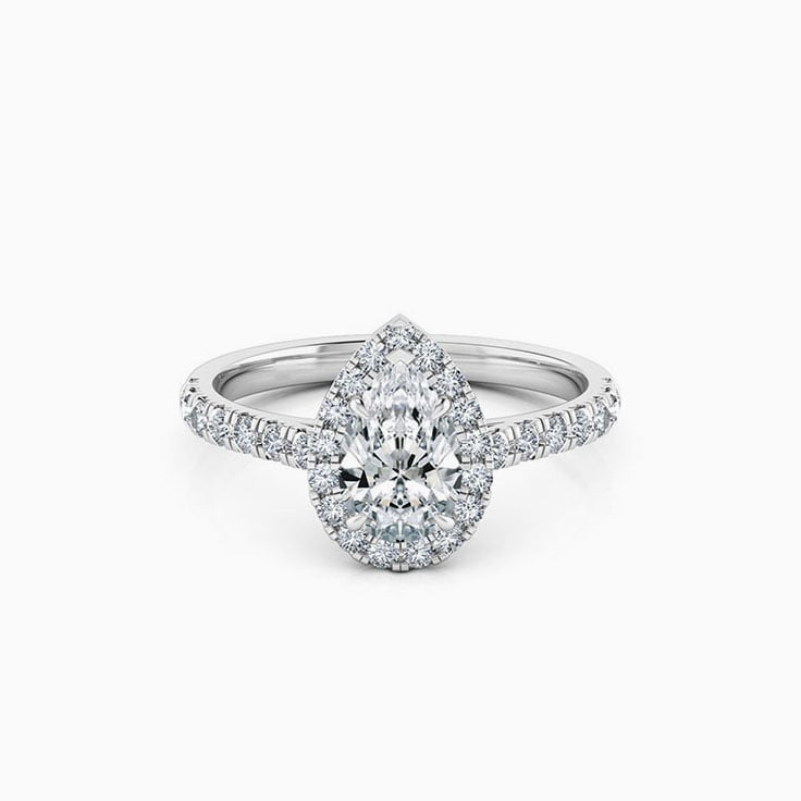 Pear cut diamond engagement ring with halo and diamond band