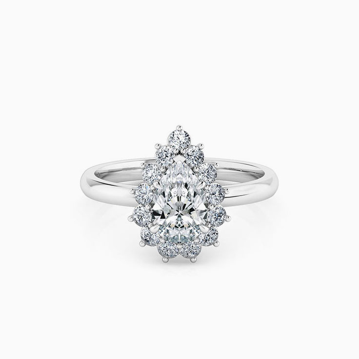 Pear cut diamond engagement ring with a floral diamond halo