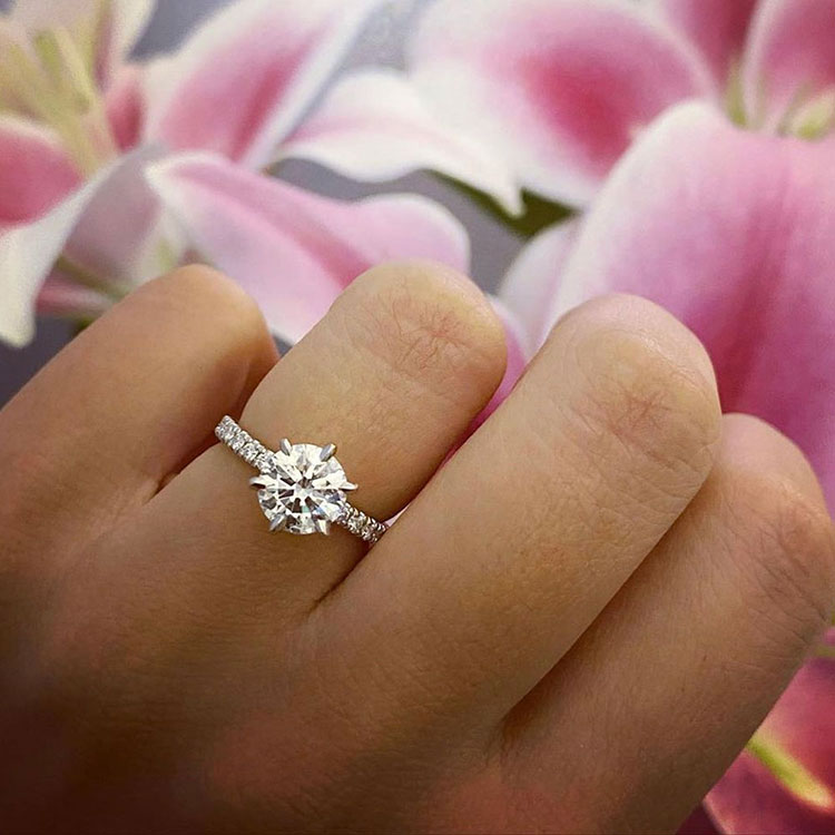 Round brilliant cut diamond in a six claw setting an diamond band